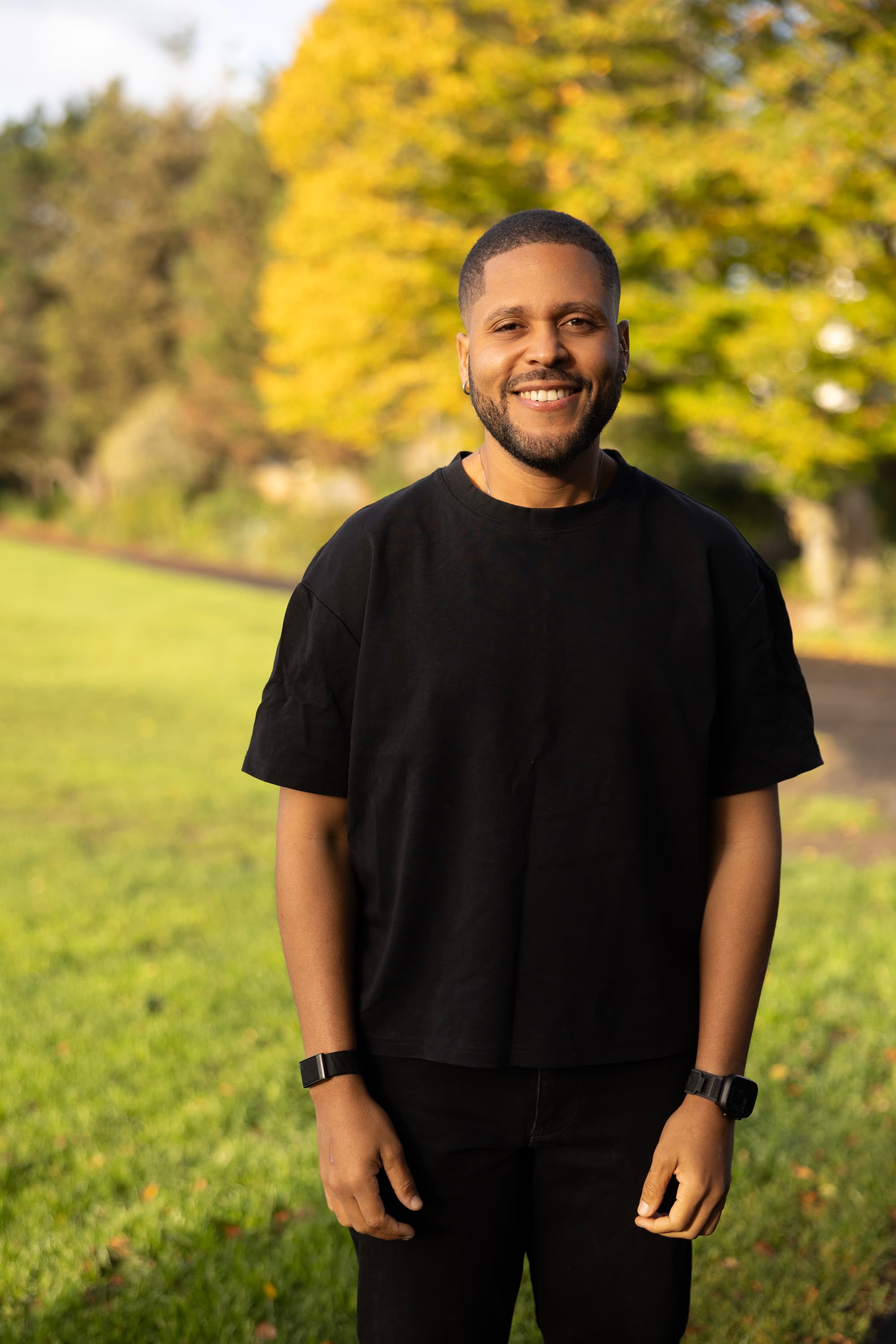 Joelson smiling in a park in golden-hour light